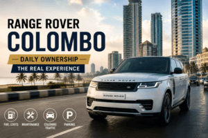 White Range Rover driving through Colombo city streets with modern skyline in the background.
