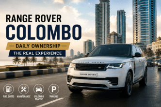 White Range Rover driving through Colombo city streets with modern skyline in the background.